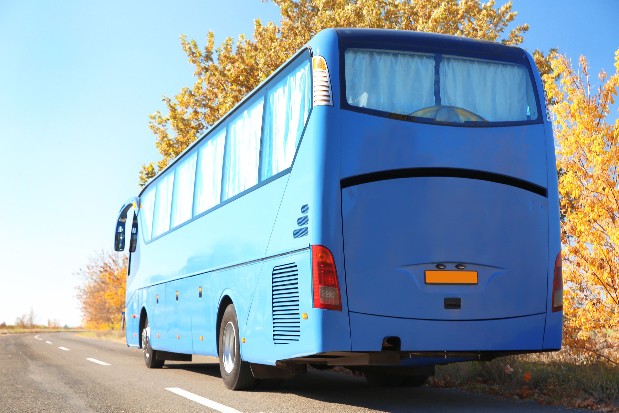 Blue coach bus on open road