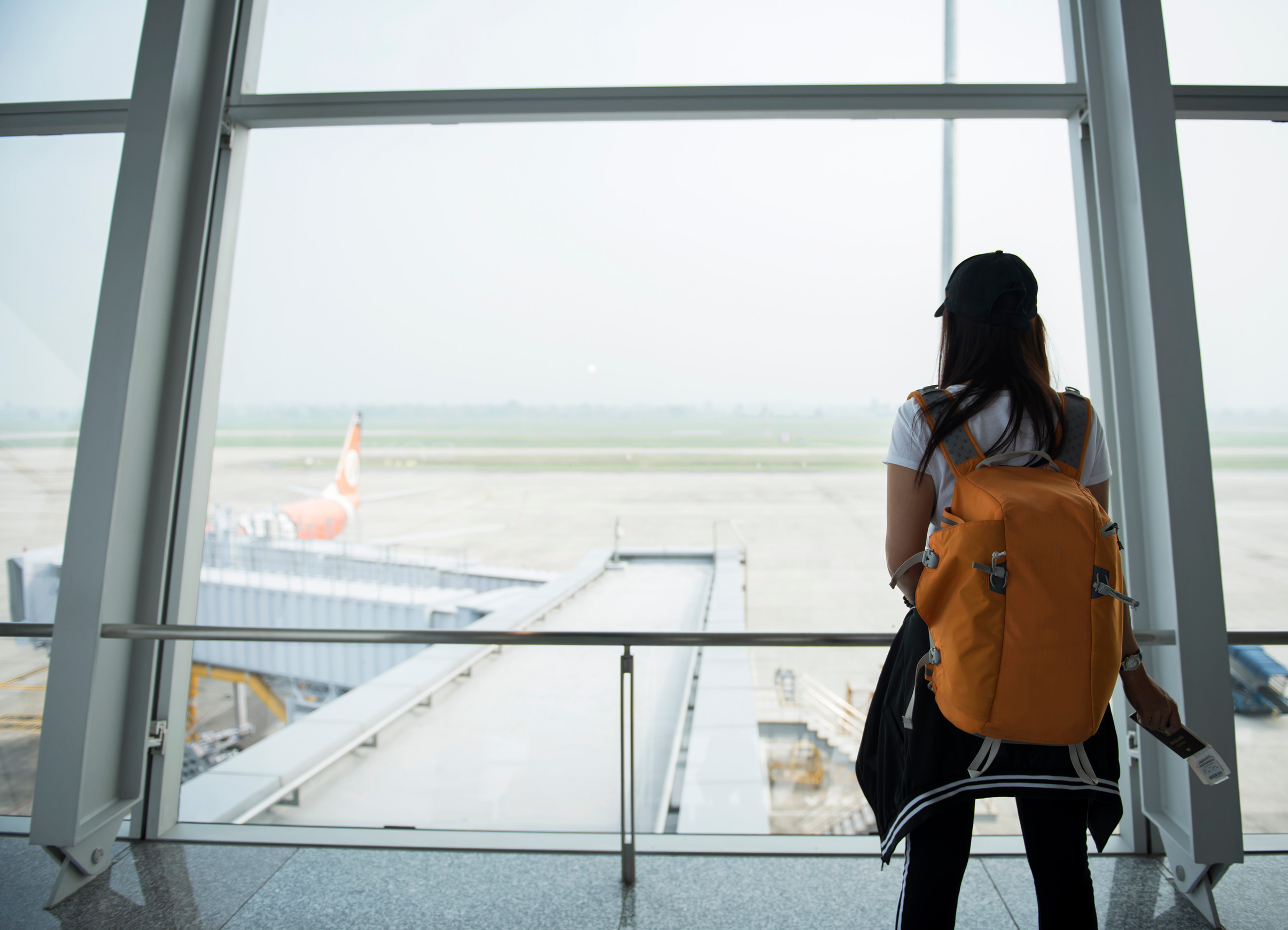 Woman traveller at airport window