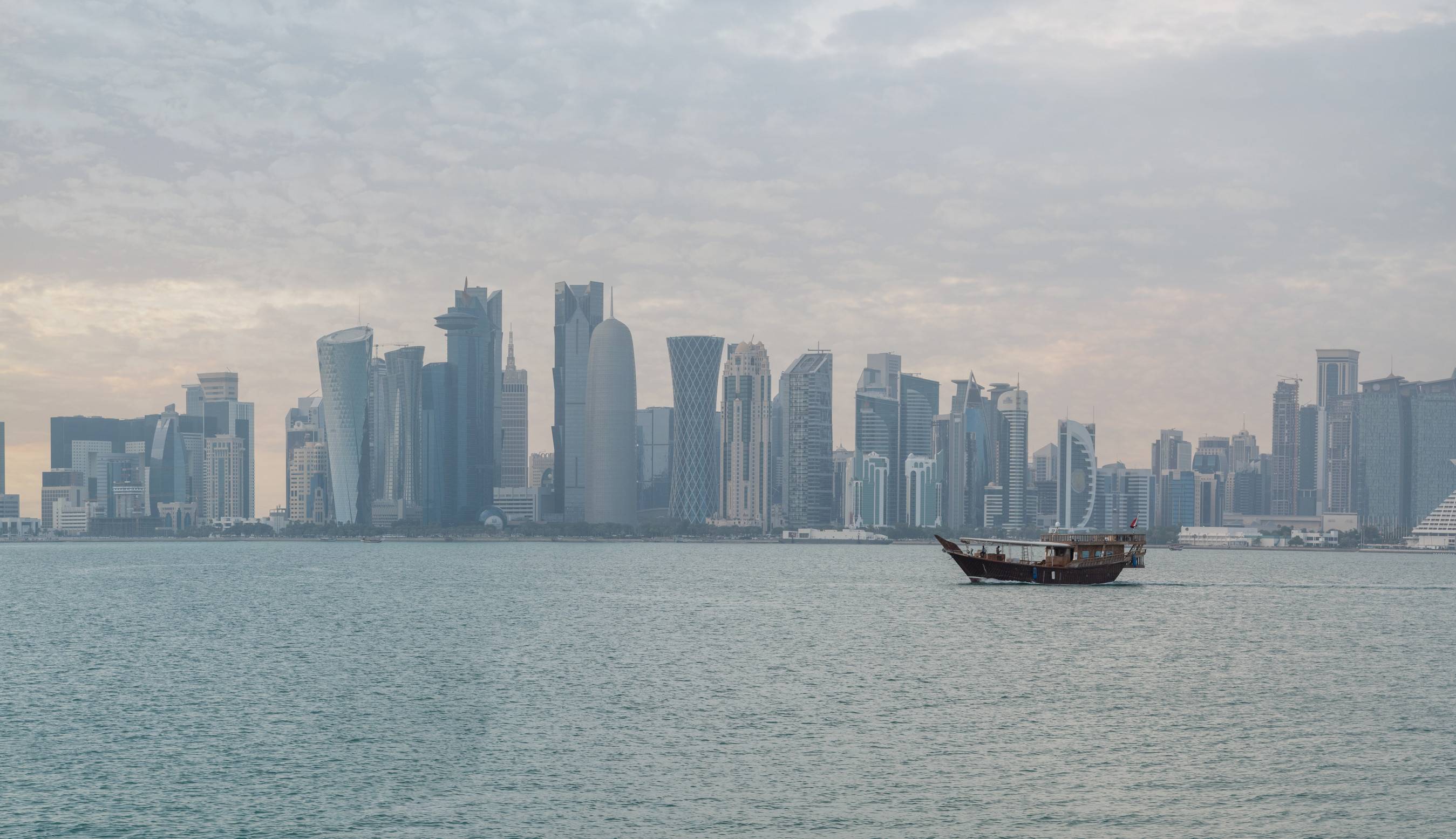 Traditional dhow boat with Doha skyline