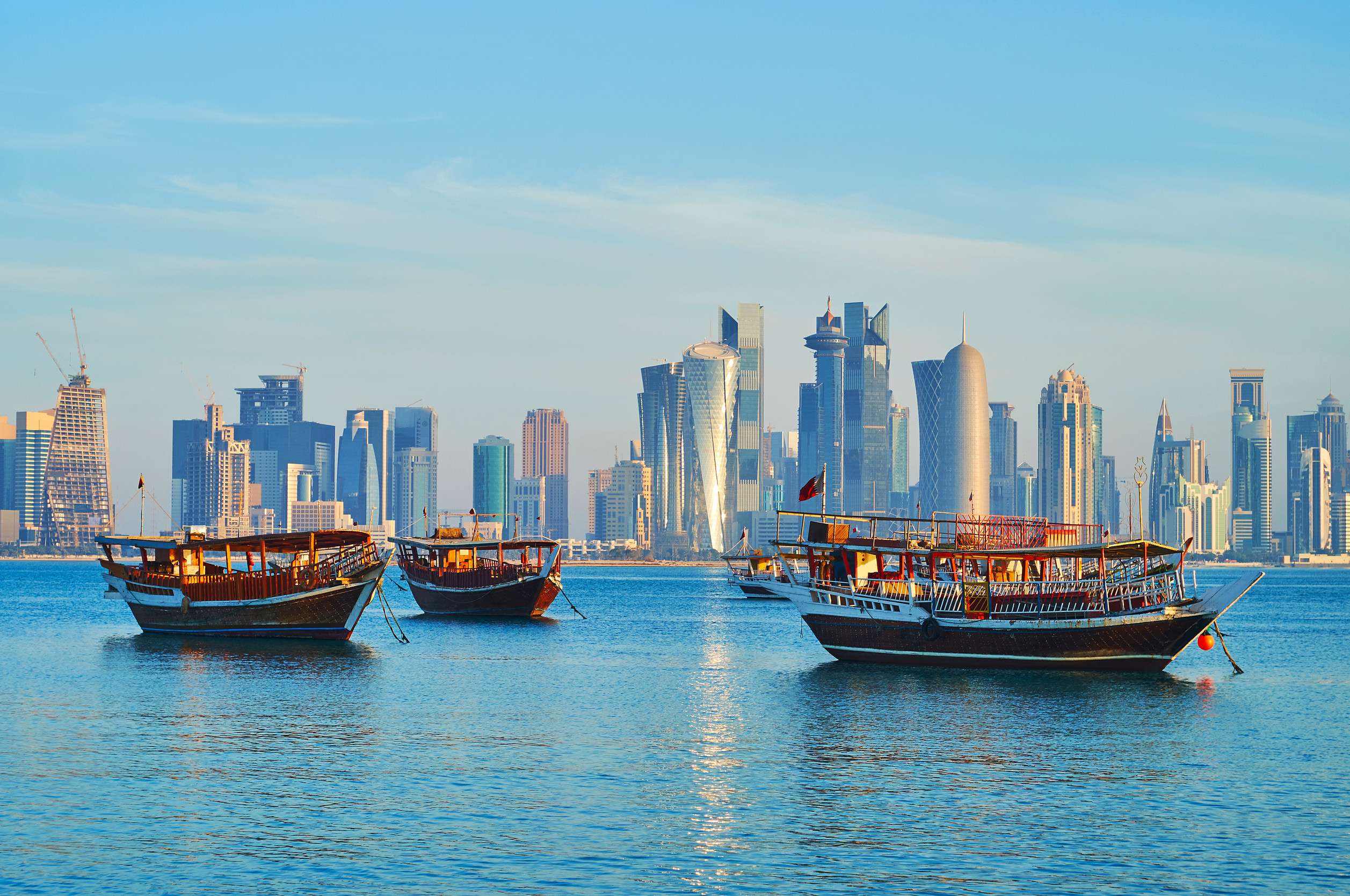 Traditional dhows with Doha city skyline